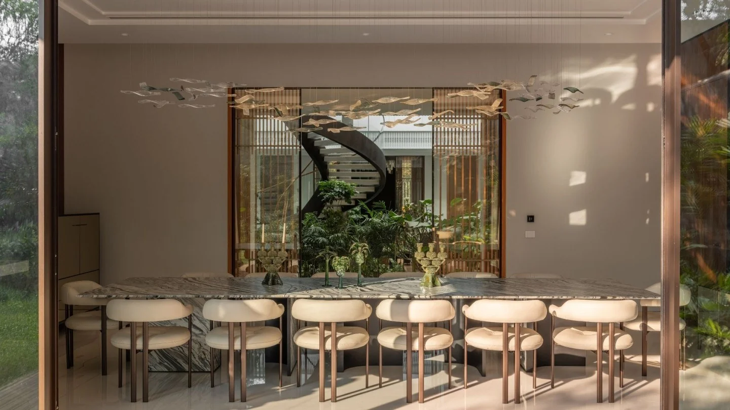 Sculptural Italamp glass lighting above a marble dining table